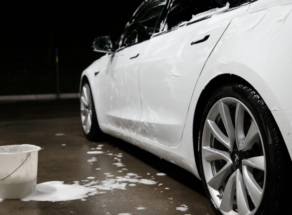 white tesla being washed